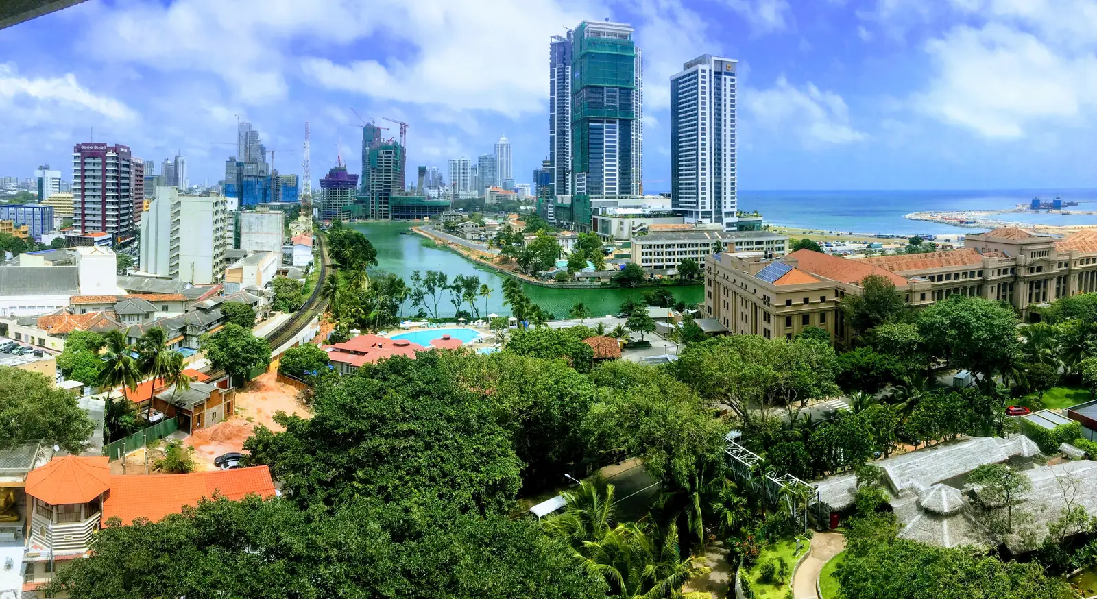 Colombo skyline, with tower cranes on buildings under construction.