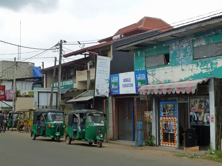 Three-wheelers on a street in Weligama